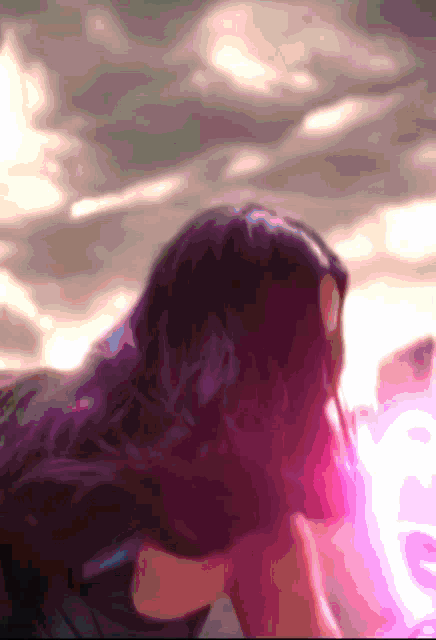 a blurry picture of a woman with long hair