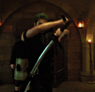 a man in a black vest is holding two swords over his head