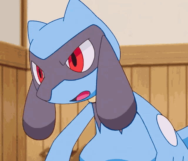 a blue cartoon character with red eyes and a white spot on his chest