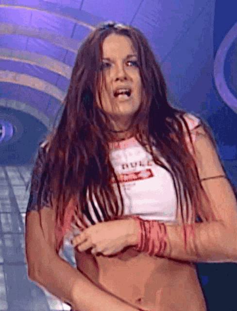 a woman with long red hair is wearing a white t-shirt that says supreme on it