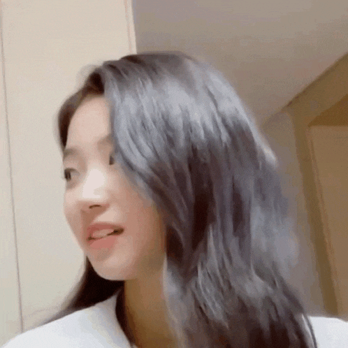 a close up of a woman 's face with long hair .