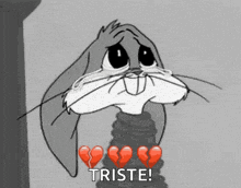 a black and white cartoon of bugs bunny with broken hearts and the words triste below him