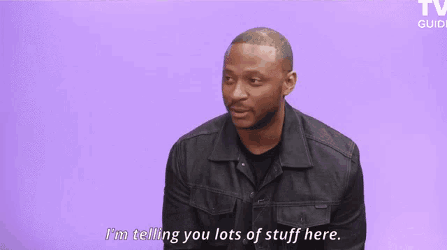 a man says i 'm telling you lots of stuff here in front of a purple background