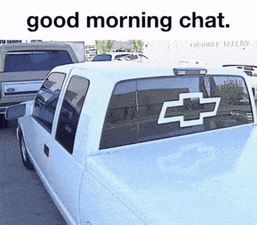 a white truck with a chevrolet logo on its back window
