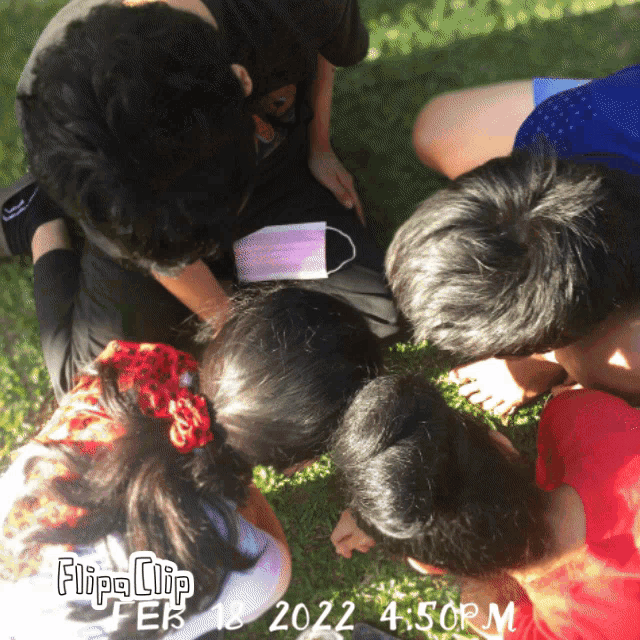 a group of children are sitting in a circle with a flipa clip watermark on the bottom right