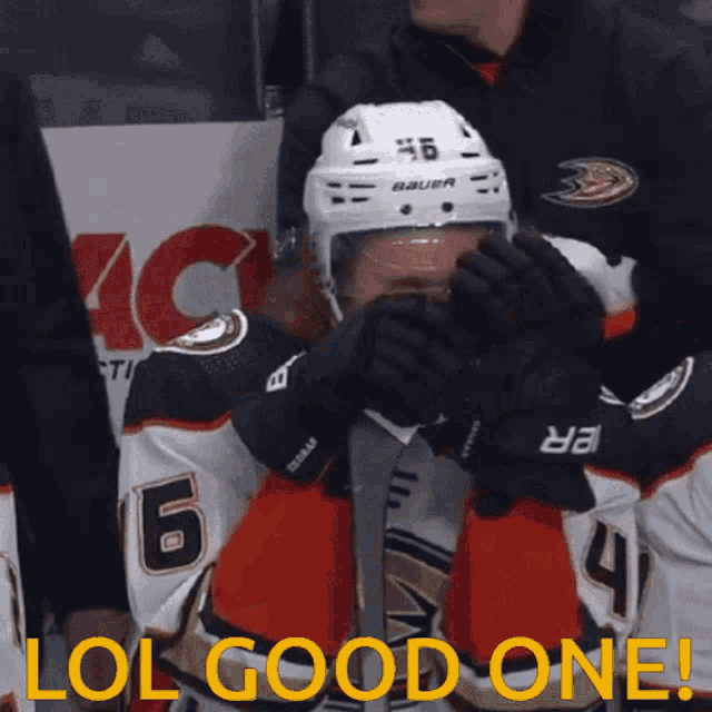a hockey player wearing a helmet that says bauer