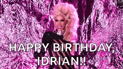 a drag queen is standing in front of a pink background and saying `` happy birthday , i 'm adrian ! ''