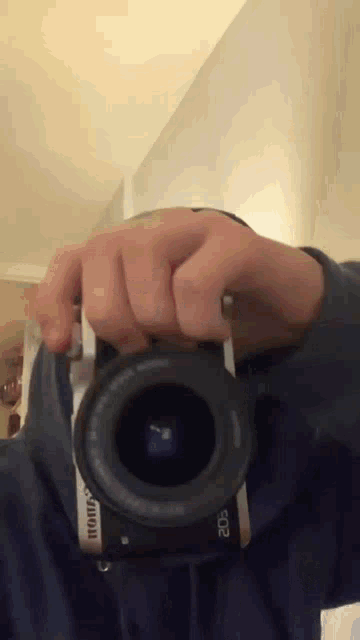 a person is taking a picture with a canon eos camera