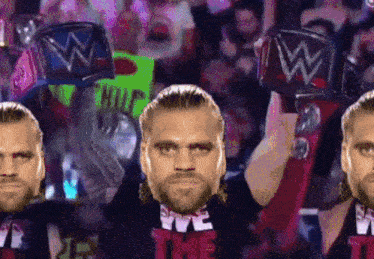 several wrestlers are holding up their championship belts and one has a sign that says help