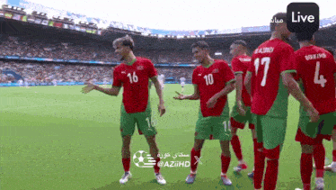 a group of soccer players are standing on a field and one of them has the number 16 on his jersey