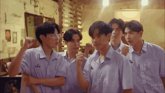 a group of young men are standing next to each other in a room with the word padan on the bottom right