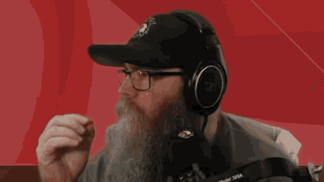 a man with a beard wearing headphones and a hat that says ' model 26ra ' on it