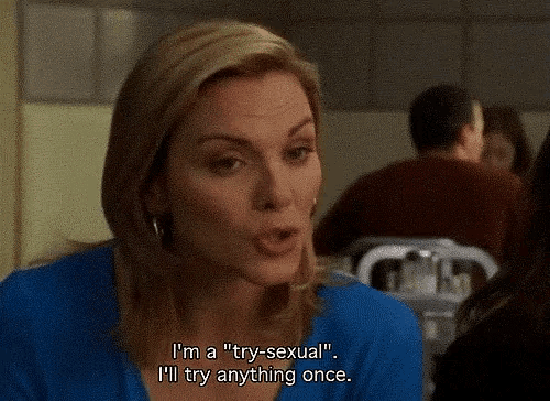 a woman in a blue shirt is saying i 'm a " try-sexual " i 'll try anything once