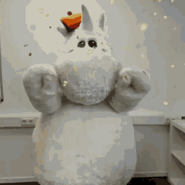 a stuffed animal in a unicorn costume with confetti falling on it