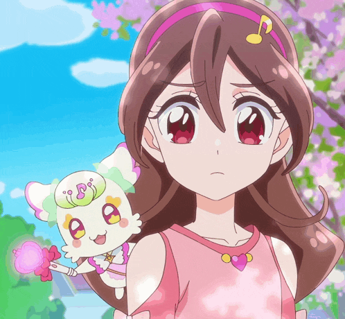 a girl is standing next to a stuffed animal with the letter b on its face