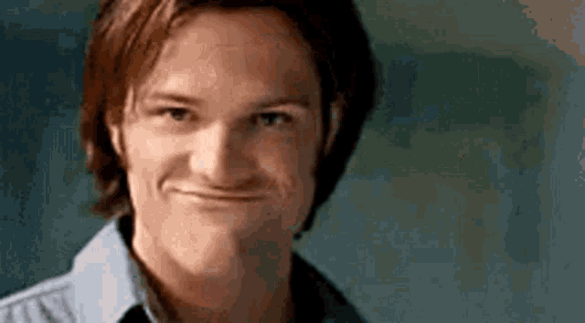 a man is making a funny face with his mouth open .