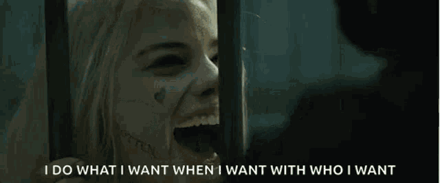 a woman is laughing behind bars and saying `` i do what i want when i want with who i want `` .