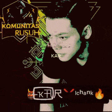 a man in a black shirt is standing in front of a green sign that says komunitas anti rusuh
