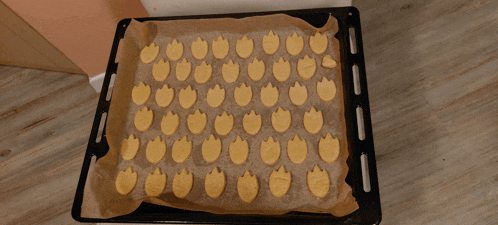 a tray of cookies shaped like flames on a piece of brown paper