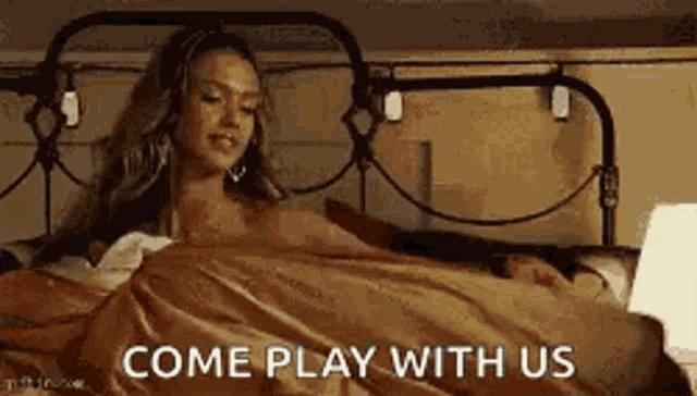 a woman is laying on a bed with a man and a lamp .