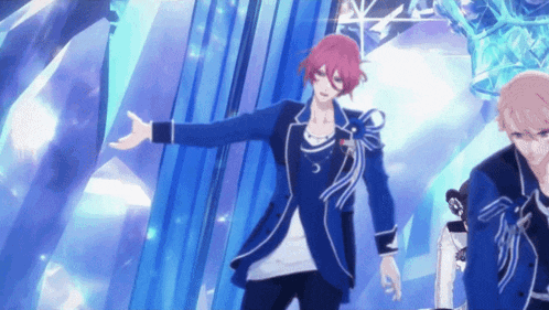 a man with red hair and a blue jacket is dancing in front of a blue curtain