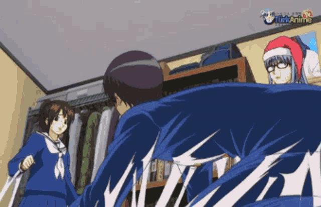 a girl in a santa hat is standing next to a man in a blue jacket