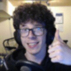 a man wearing headphones and glasses is giving a thumbs up sign