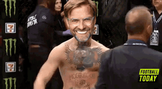 a man with a tattoo on his chest that says mcgregor is smiling