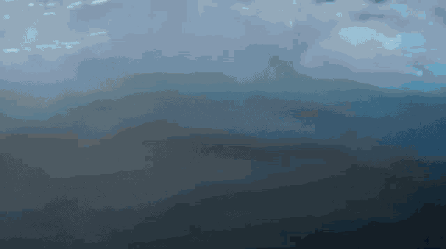 a dark blue background with a few white clouds in it