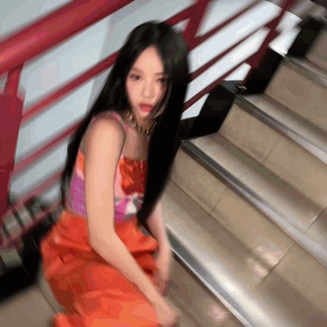 a blurry picture of a woman sitting on the stairs