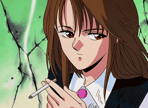 a girl with long brown hair is smoking a cigarette in front of a green wall