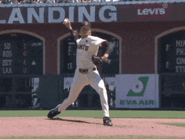 a giants pitcher winds up to throw the baseball