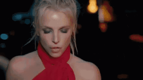 a close up of a woman wearing a red scarf and a ponytail .