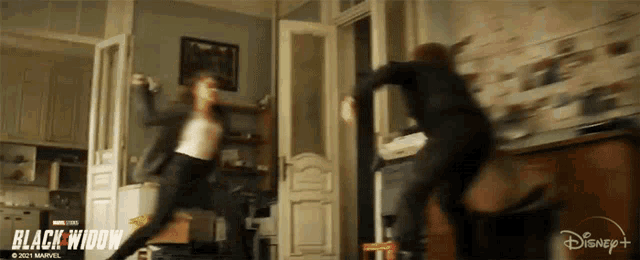 two women are fighting in a room with a sign that says black widow on it