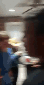 a blurry photo of a person holding a tray of food