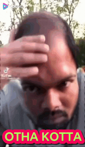 a man with a beard holds his hand to his forehead with the words otha kotta written below him