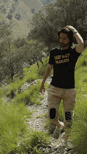 a man wearing a saint kelley bearcats t-shirt