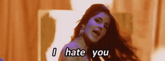 a woman is singing a song and saying `` i hate you '' while dancing .