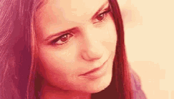 a close up of a woman 's face with a serious expression .