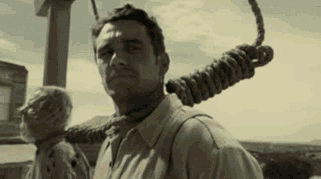 a man with a rope around his neck and another man behind him