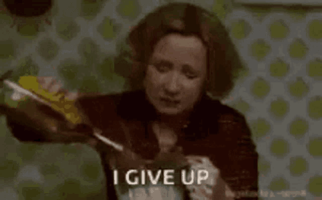 a woman is pouring a bottle of alcohol into a glass and saying `` i give up '' .