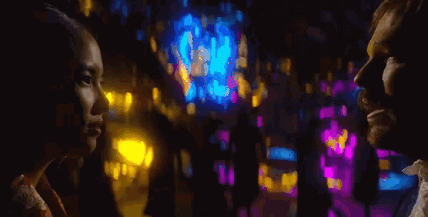 a man and a woman are looking at each other in a blurry photo