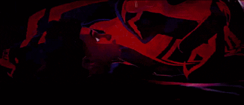 a person is falling down in a dark room with a red light behind them .
