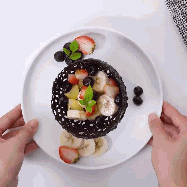 a white plate topped with fruit and chocolate