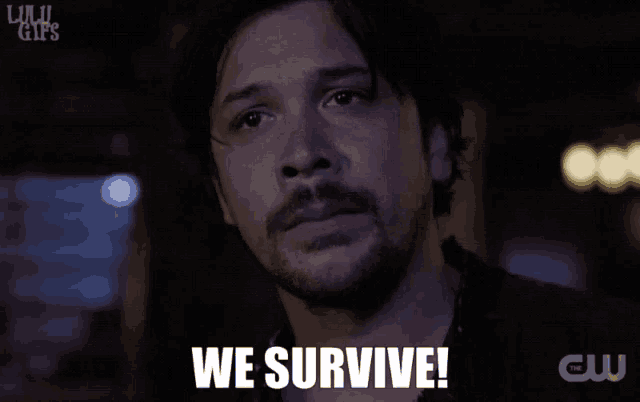 a man with a beard says we survive in a gif