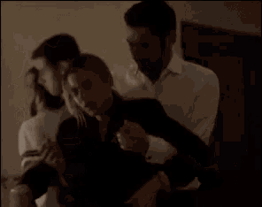 a man and a woman are hugging each other in a room .