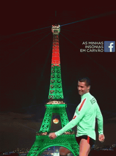 a man stands in front of an eiffel tower that is green