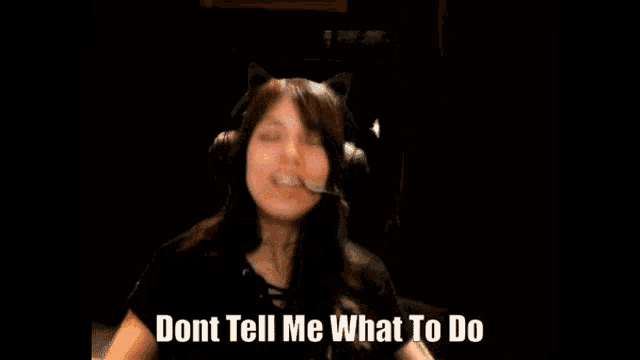 a woman wearing headphones and a cat ear headset says " dont tell me what to do "