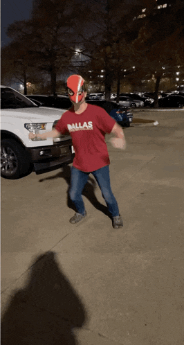 a man wearing a dallas shirt and a mask is dancing