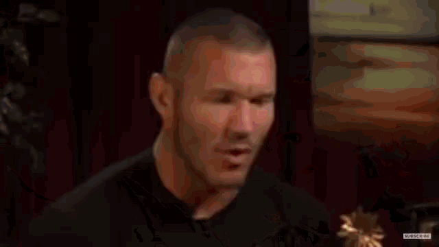 two men are facing each other in a wrestling ring .